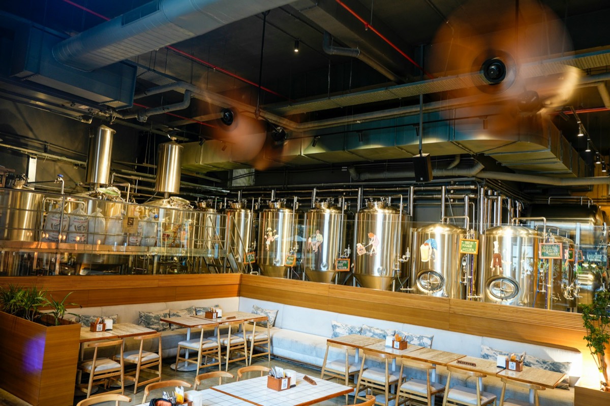 Brewery dining room beside steel tanks